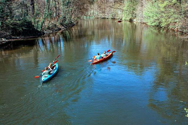 A kayaker paddling on calm open water